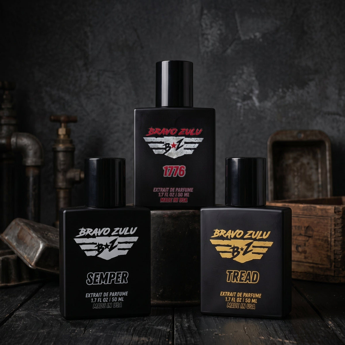 A professional 2048x2048 product collection photo featuring three matte black Bravo Zulu cologne bottles arranged on a dark, rustic wooden surface. 