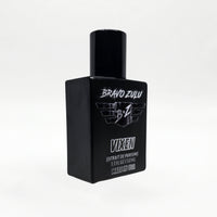 Bravo Zulu Flagship Soap Company VIXEN Extrait de Parfum bottle, angled three-quarter view, showing the heavy matte black glass bottle with black cap and silver BRAVO ZULU B★Z winged logo, VIXEN name, Extrait de Parfume 1.7 FL OZ / 50 ML, and Made in USA text, on a seamless white studio background.