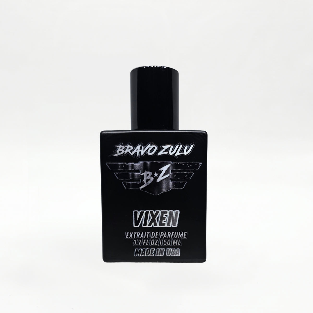 Front-facing studio product shot of Bravo Zulu VIXEN Extrait de Parfum by Flagship Soap Company. The heavy matte black glass bottle with matching black cap is centered on a clean white background, displaying the silver BRAVO ZULU B★Z winged logo, VIXEN name, Extrait de Parfume 1.7 FL OZ / 50 ML, and Made in USA text.