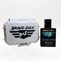 Bravo Zulu COASTAL RECON Extrait de Parfum by Flagship Soap Company displayed side by side with its closed white rugged tactical case featuring the black BRAVO ZULU B★Z winged logo, on a clean white studio background.