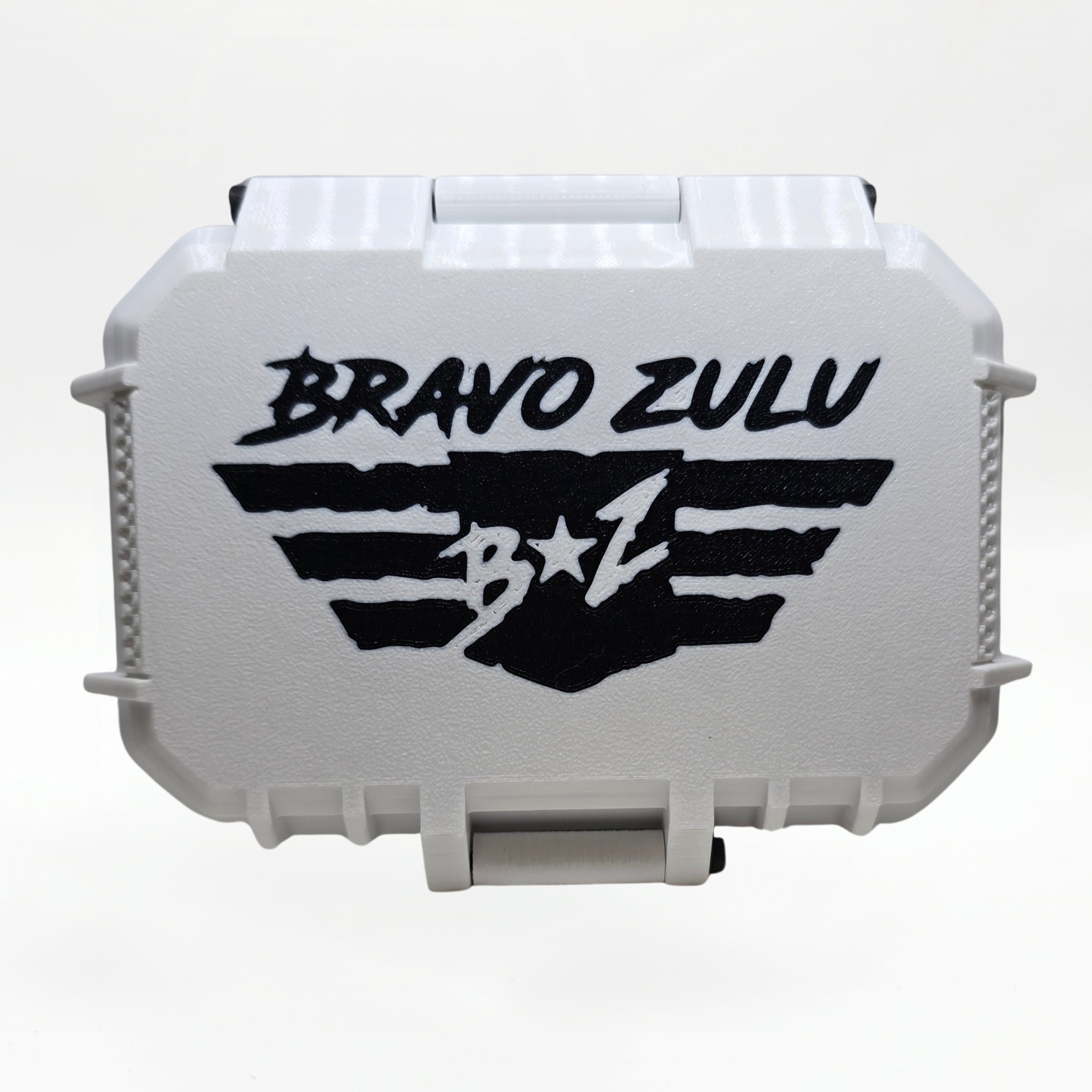 Closed white rugged tactical travel case for Bravo Zulu COASTAL RECON Extrait de Parfum by Flagship Soap Company, front view showing the black BRAVO ZULU B★Z winged logo on the case exterior, on a seamless white studio background.