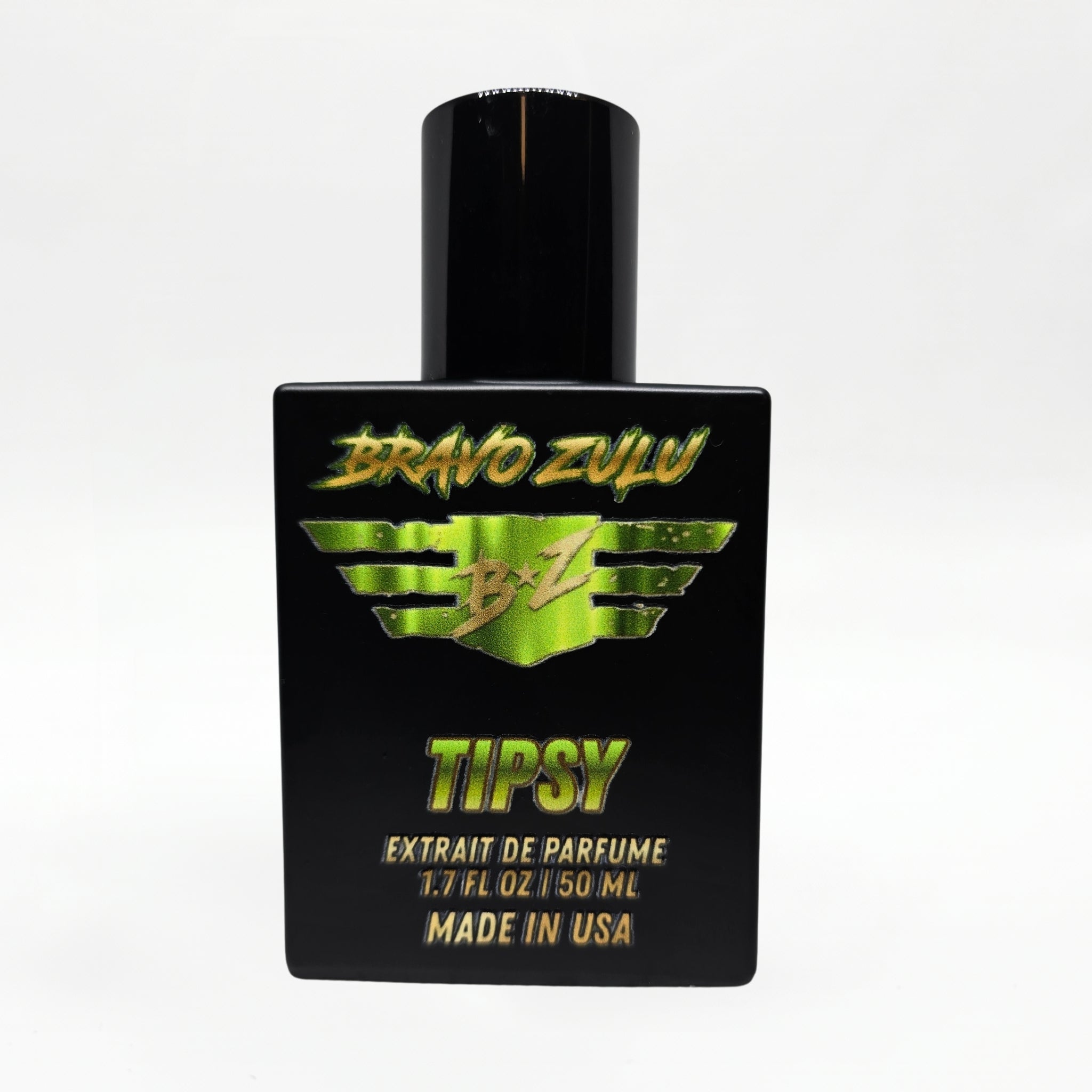 Front-facing studio product shot of Bravo Zulu TIPSY Extrait de Parfum by Flagship Soap Company. The heavy matte black glass bottle with matching black cap is centered on a clean white background, displaying the lime-green BRAVO ZULU B★Z winged logo, TIPSY name, Extrait de Parfume 1.7 FL OZ / 50 ML, and Made in USA text.