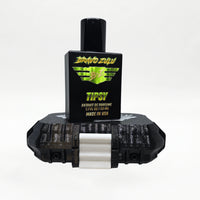 Bravo Zulu TIPSY Extrait de Parfum by Flagship Soap Company shown docked inside its open black rugged tactical case, the matte black glass bottle secured in the honeycomb interior insert opposite the white foam-lined lid, on a seamless white studio background.
