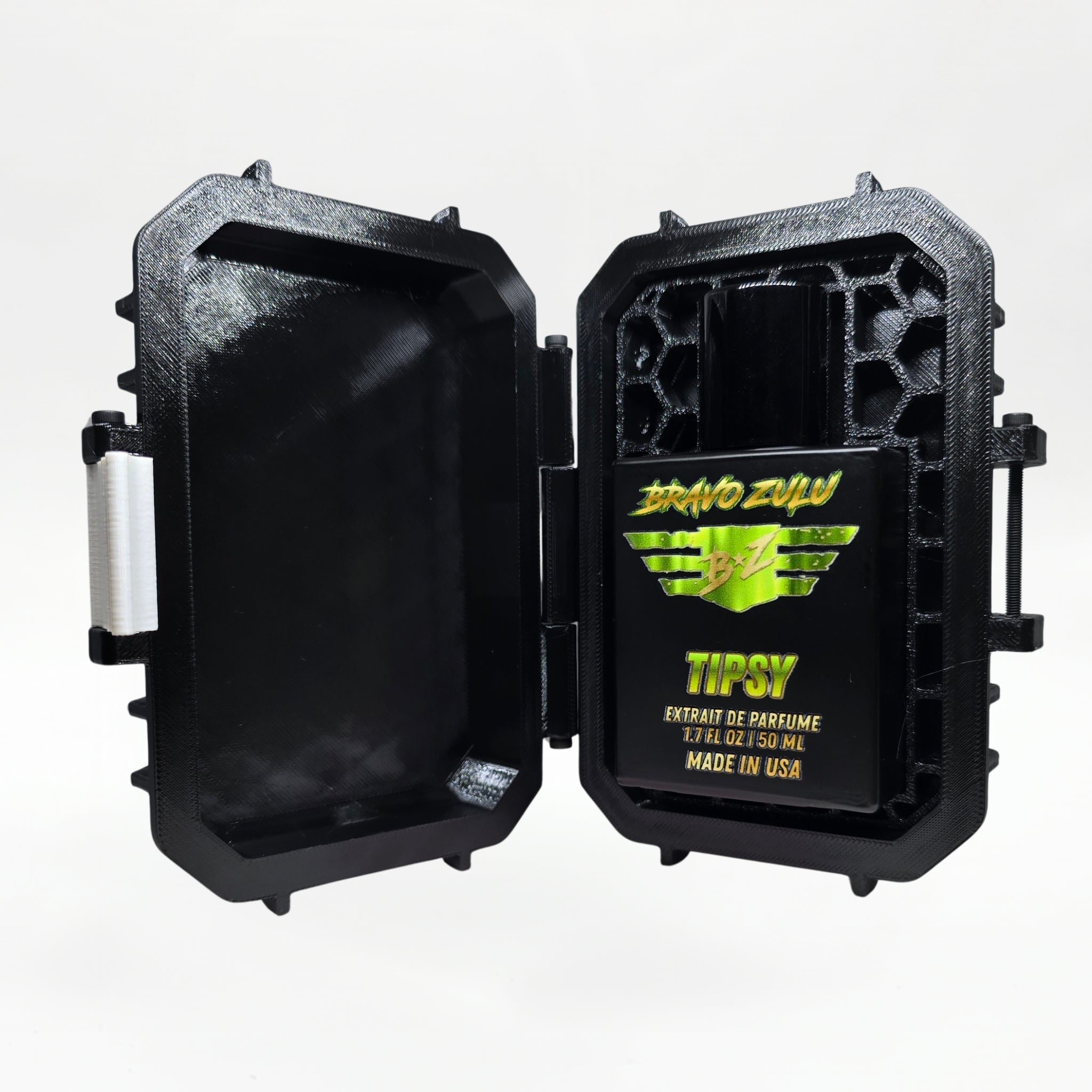 Bravo Zulu TIPSY Extrait de Parfum by Flagship Soap Company displayed side by side with its closed black rugged tactical case featuring the white BRAVO ZULU B★Z winged logo, on a clean white studio background.