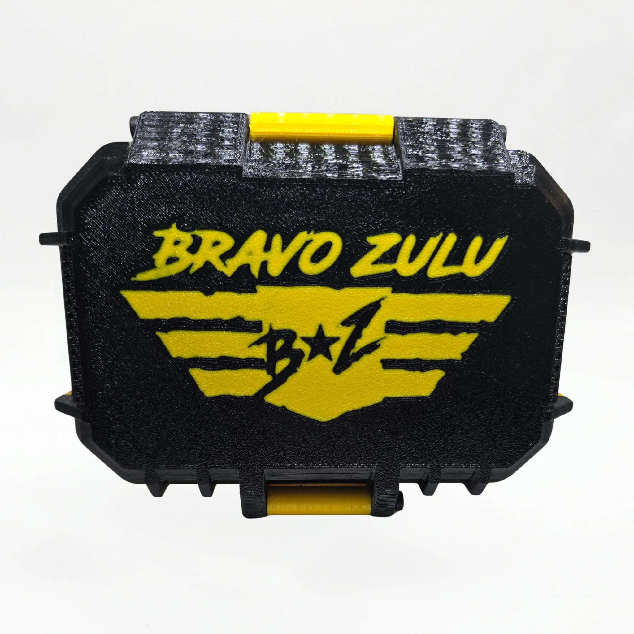 Bravo Zulu RADIANT Extrait de Parfum by Flagship Soap Company displayed side by side with its closed yellow-and-black rugged tactical case featuring the gold BRAVO ZULU B★Z winged logo, on a clean white studio background.