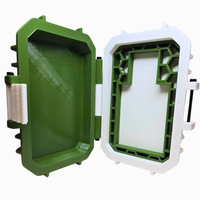 Green and white plastic container with open lid on a white background