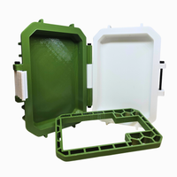 Green and white plastic container with a lid on a white background