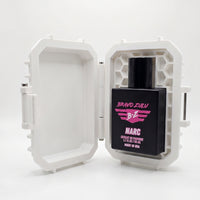 Front studio product shot of the Bravo Zulu NARC Extrait de Parfum men's cologne bottle securely nested inside its open, white custom tactical case, isolated on a seamless white background. The heavy matte black glass bottle is perfectly framed by the rugged case’s internal honeycomb protective structure, clearly displaying the vibrant pink and white stenciled branding and "Made in USA" text.