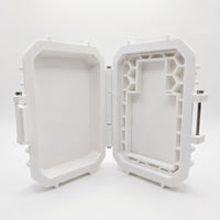 Front studio product shot of the open, empty white custom tactical case for Bravo Zulu NARC Extrait de Parfum cologne, isolated on a seamless white background. The rugged protective hardware case is open at an angle, clearly showing the internal molded layout and honeycomb grid structure engineered to lock the matte black glass bottle securely into place for travel.