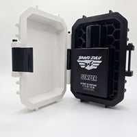 An open, custom-engineered rugged protective case showcasing the SEMPER Extrait de Parfum bottle by Bravo Zulu on a clean white background. The heavy matte black glass bottle is securely locked inside the black textured, hexagonal-patterned interior of the tactical case, which features a stark Vanguard White exterior lid. This premium 30% concentration, American-built cologne delivers a dominant, unyielding scent profile of cold ocean marine, rugged earthy woods, and sharp citrus.