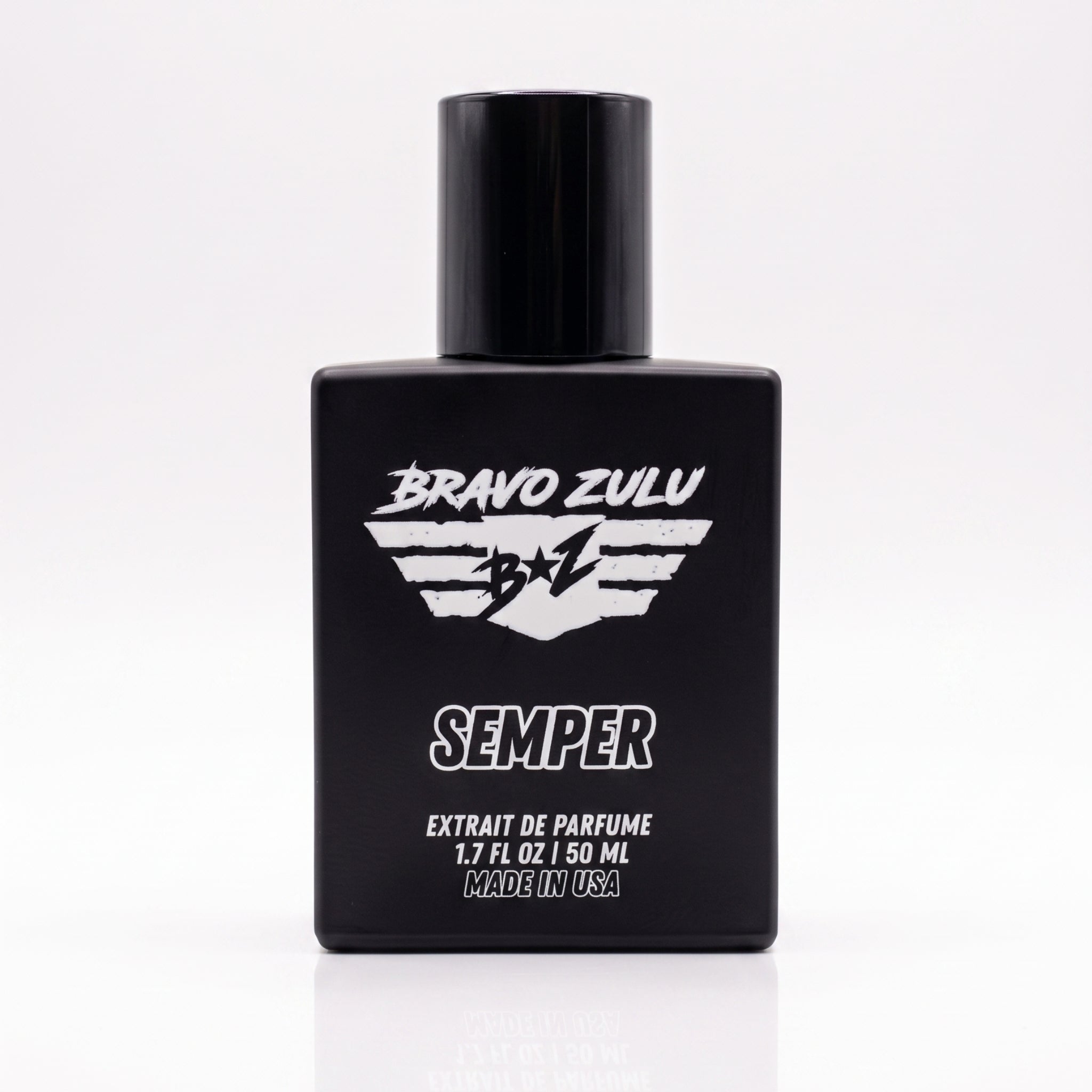 A crisp e-commerce product packshot of SEMPER Extrait de Parfum by Bravo Zulu, centered on a seamless white background with a clear reflection below. The heavy tactical matte black glass bottle prominently features sharp white branding, a flight-wing B+Z shield logo, and bold text. This premium, American-built cologne represents a fiercely elite standard of quality, engineered with a commanding 30% concentration for maximum permanence.