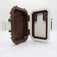 Empty custom tactical storage case for Flagship Soap Company's Whiskey Girl perfume. An open, rugged protective travel case built with a Bourbon Brown lid and white accents, showcasing a precision-molded internal frame engineered to lock in a 40ml bottle of 30% concentration Extrait de Parfum, displayed on a minimalist white backdrop.