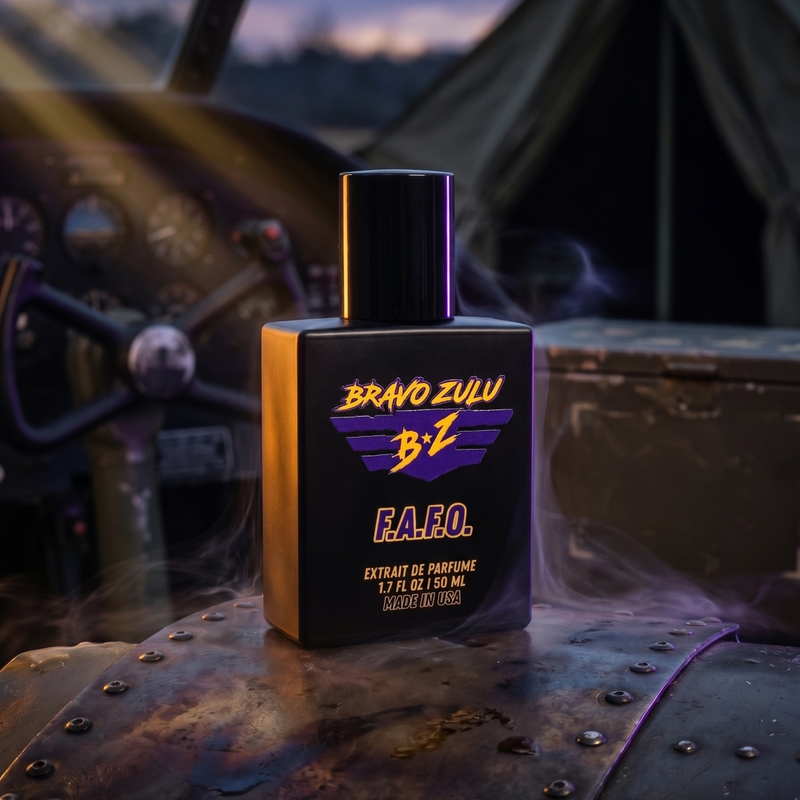 Matte black glass bottle of F.A.F.O. Extrait de Parfum by Flagship Soap Company featuring the purple and yellow Bravo Zulu BZ logo. The 30% concentration masculine cologne stands on a rugged, riveted metal surface surrounded by dramatic smoke waves. In the tactical background, a military aircraft cockpit and an olive drab field tent are visible under a twilight sky with low-key, calculated lighting.