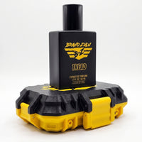 Flagship Soap Company TREAD Extrait de Parfum tactical matte black cologne bottle stacked on top of its closed custom black and yellow tactical hardware case. Both items feature the high-contrast yellow Bravo Zulu brand logo, displayed on a clean white background.