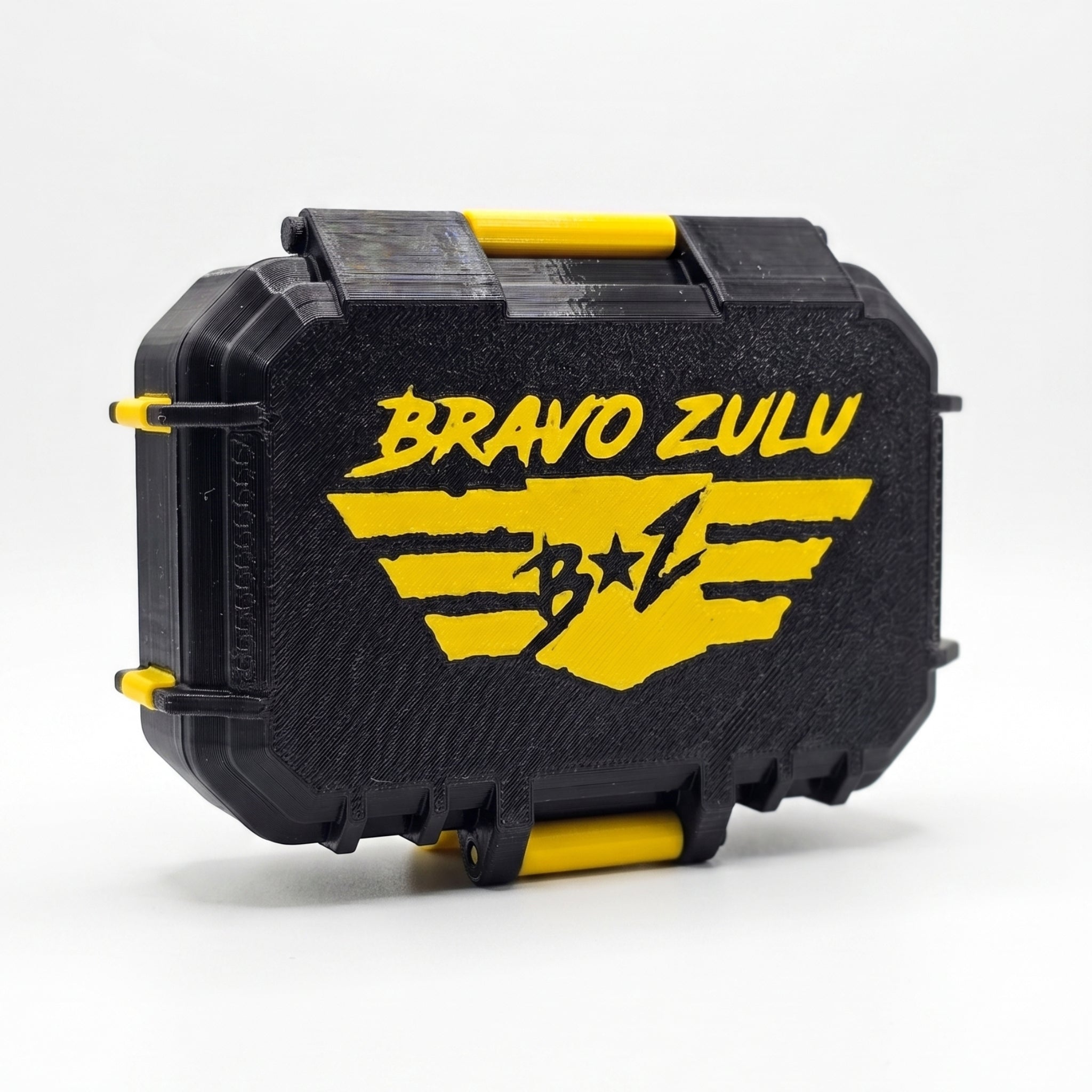 Flagship Soap Company TREAD custom tactical fragrance case shown closed from an angle against a seamless white background. The heavy-duty protective case features a textured matte black finish accented with vibrant strike yellow hardware hinges and a prominent yellow Bravo Zulu winged logo across the front.