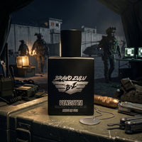 A high-impact product photograph featuring the Bravo Zulu VENDETTA cologne bottle front and center, set against a dramatic, military operations background at night evoking a strategic tactical raid.

The heavy, tactical matte black glass bottle sits anchored on a rugged, olive drab military crate alongside mission-essential hardware, including a multi-tool, a tactical flashlight, communications gear, and a blank metal dog tag on a ball chain. The silver-embossed bottle label prominently displays the "BRAVO 