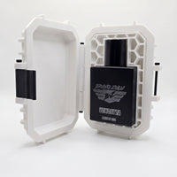 A professional product photograph showcasing the Bravo Zulu VENDETTA fragrance nestled inside its premium presentation hardware against a clean white background.

The heavy, tactical matte black glass bottle is displayed sitting upright inside an open, custom-engineered rugged protective case. The custom tactical case is finished in a clean white color with contrasting black hardware components, featuring a distinctive molded honeycomb pattern on the interior right panel that securely blocks the bottle in p