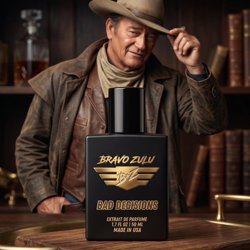 Matte black tactical glass bottle of Bravo Zulu BAD DECISIONS Extrait de Parfum by Flagship Soap Company, displayed on a rustic wood tray. The 30% concentration premium whiskey-themed cologne features gold texturing. In the atmospheric, moody background, a rugged man resembling John Wayne tips his cowboy hat in a dimly lit study with a glass decanter and books.