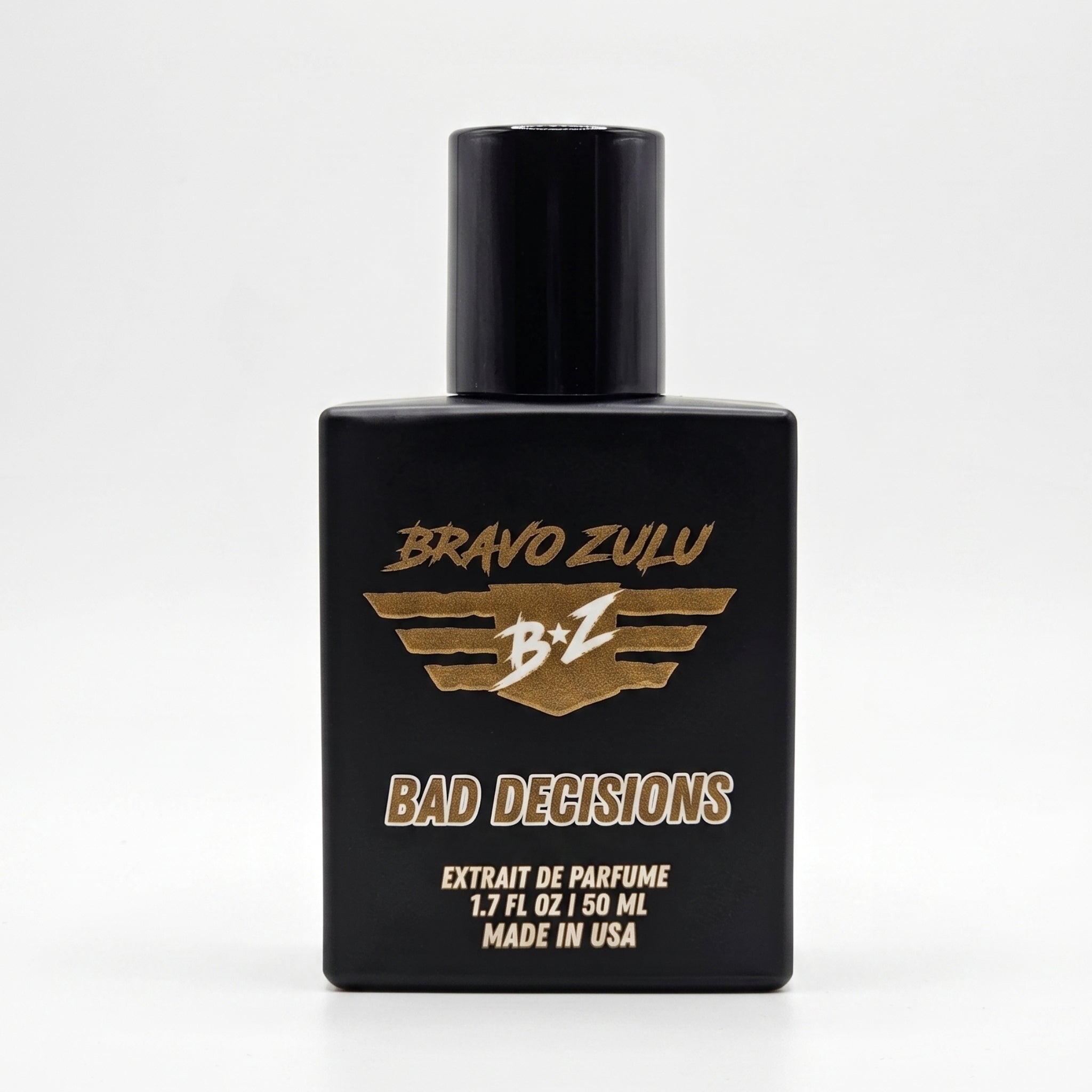Bravo Zulu BAD DECISIONS Extrait de Parfum by Flagship Soap Company. A premium 30% concentration whiskey-themed men's cologne housed in a heavy tactical matte black glass bottle, centered against a clean, solid white studio background. The front display showcases the gold-textured Bravo Zulu logo and white "BAD DECISIONS" text, emphasizing an American-built, high-end masculine fragrance profile.