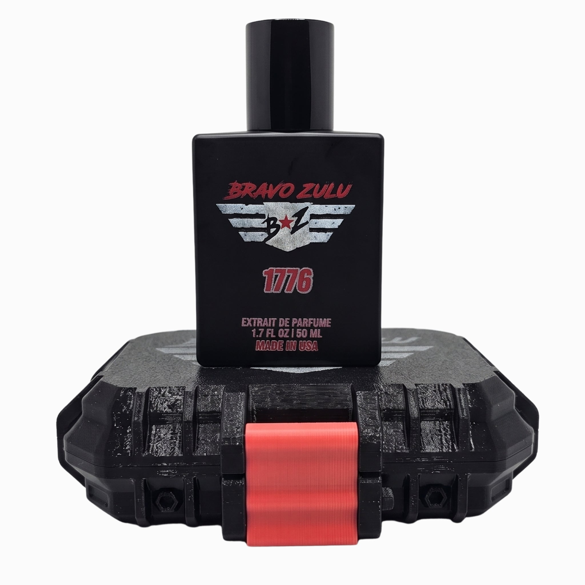 Bravo Zulu 1776 Extrait de Parfum matte black cologne bottle standing on top of its rugged, black tactical protective case with a crimson red latch, set against a clean white background. The bottle label prominently displays the tactical wings logo and red 1776 text for the American-made, 30% concentration Bay Rum masculine fragrance.