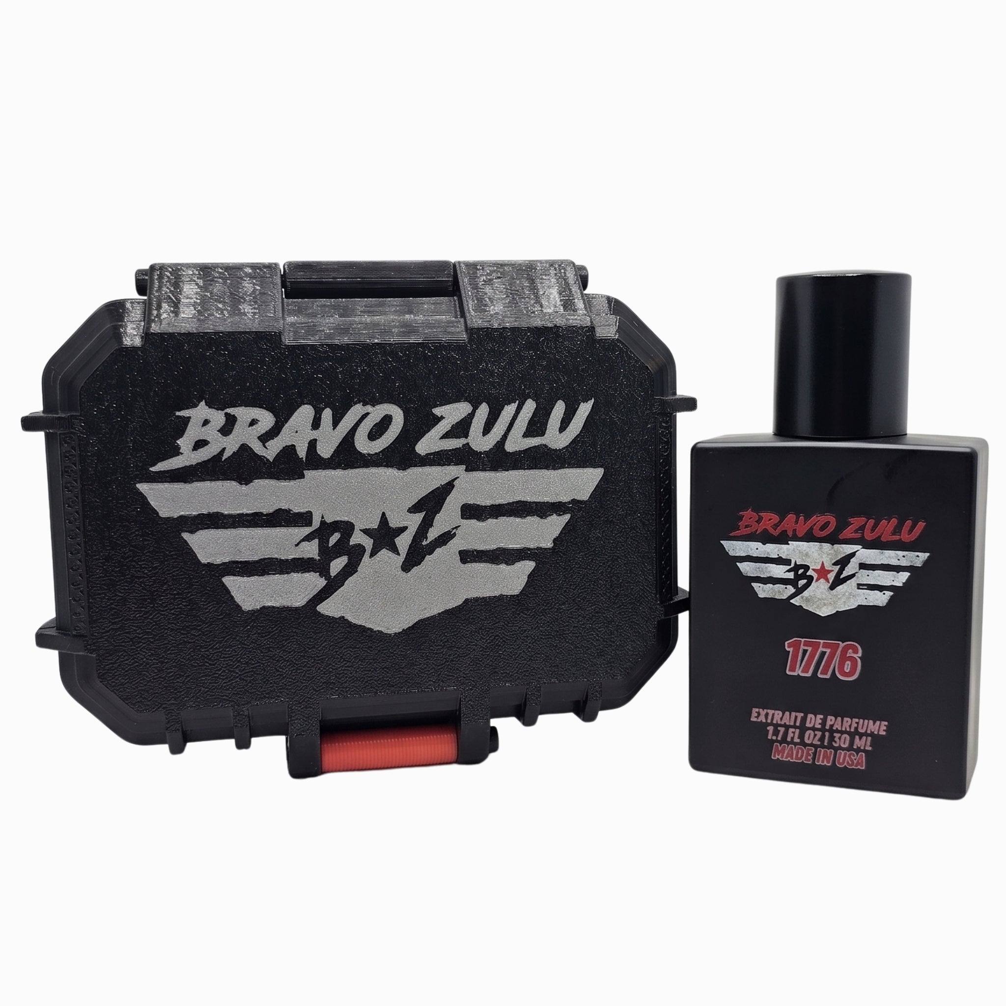 A product image of Bravo Zulu's 1776 Extrait de Parfum matte black cologne bottle standing next to its closed, rugged black tactical storage case on a plain white background. The heavy-duty case prominently features a silver-gray debossed tactical wings logo and a crimson red latch, while the bottle label showcases the matching silver wings emblem and prominent red 1776 text. This setup represents the high-performance presentation of the American-made, 30% oil concentration masculine Bay Rum fragrance line.