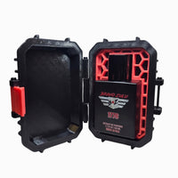 Bravo Zulu's 1776 Extrait de Parfum matte black cologne bottle showcased inside an open, rugged black tactical case with a crimson red honeycomb interior insert. The custom 3D-printed texture case is angled against a white background, displaying its bright red front closure latch. The bottle label prominently features the silver tactical wings logo and red 1776 text, emphasizing the heritage-inspired, aggressive masculine profile of this 30% concentration American-made Bay Rum fragrance.