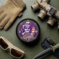 Flagship Soap Company Angry Charlie beard butter tin featuring the purple bearded skull logo, surrounded by professional tactical equipment and an MKC knife.