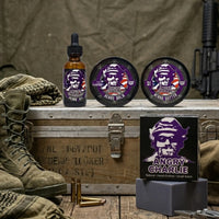 Flagship Soap Company Angry Charlie product line, including beard oil, balm, butter, and bar soap, displayed on a vintage military footlocker with combat boots and an AR-15.