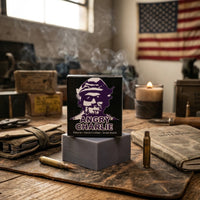 Angry Charlie natural soap bar with cedarwood and vanilla scent. Veteran-made small-batch men's soap on a rustic workshop table with patriotic branding.