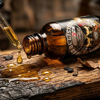 A close-up of Bad Decisions Beard Oil being applied from a glass dropper onto a charred oak surface. The oil features a rugged whiskey and oak scent, formulated with authentic Buffalo Trace Bourbon for hair health.