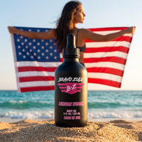 Bravo Zulu Merican Woman Body Oil dropper bottle studio product shot on white background, matte black glass with pink Bravo Zulu B★Z logo, 4 fl oz / 120 mL