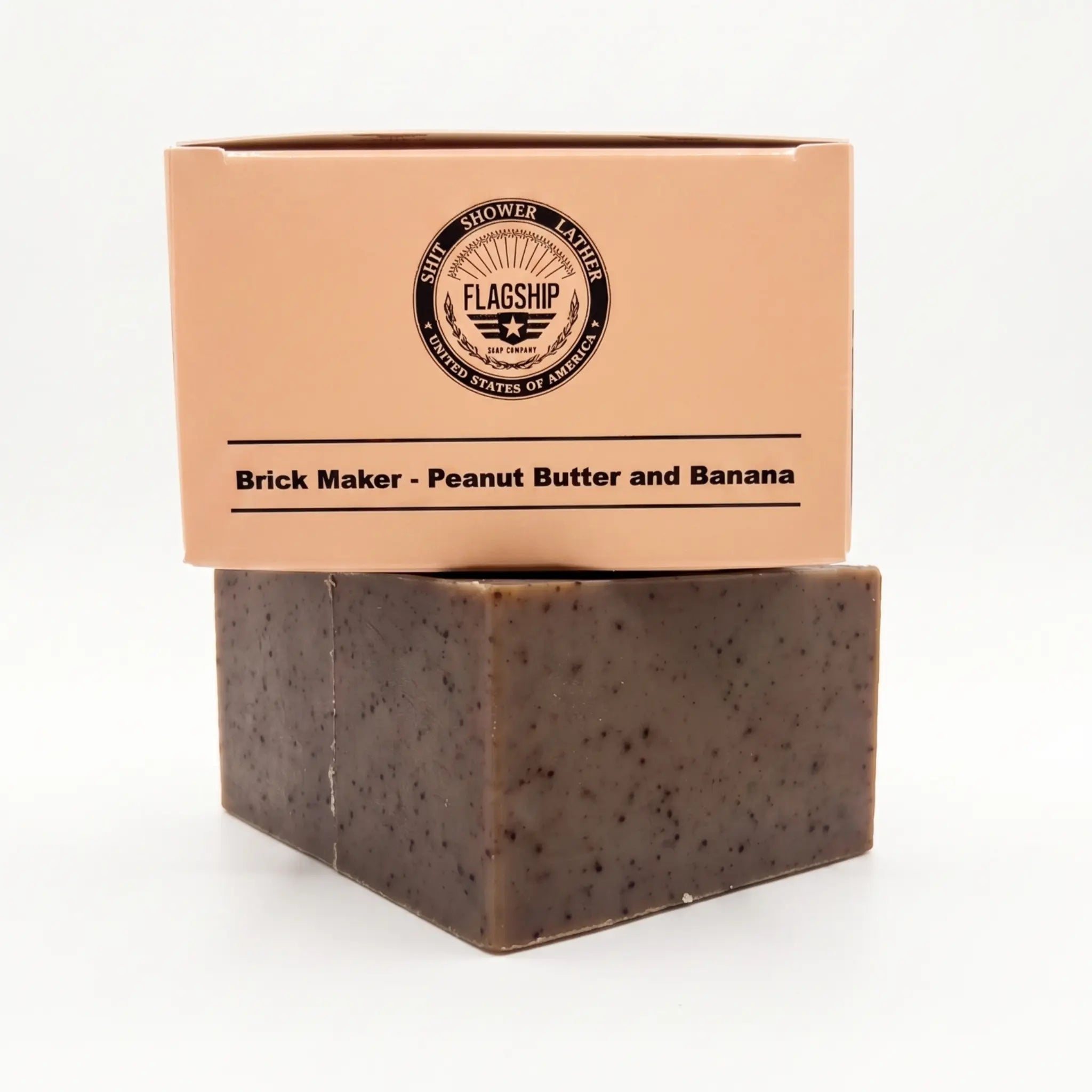 Frontal view of the Flagship Soap Company "Brick Maker" natural bar soap (5.56 OZ) in its beige box. The box displays the "Brick Maker: Peanut Butter and Banana" scent, the military-themed "Warfighter Approved" checklist, and "Flagship Idaho, USA B3815" crest. This massive, durable bar is hard-milled for a longer life and non-stripping cleanse.