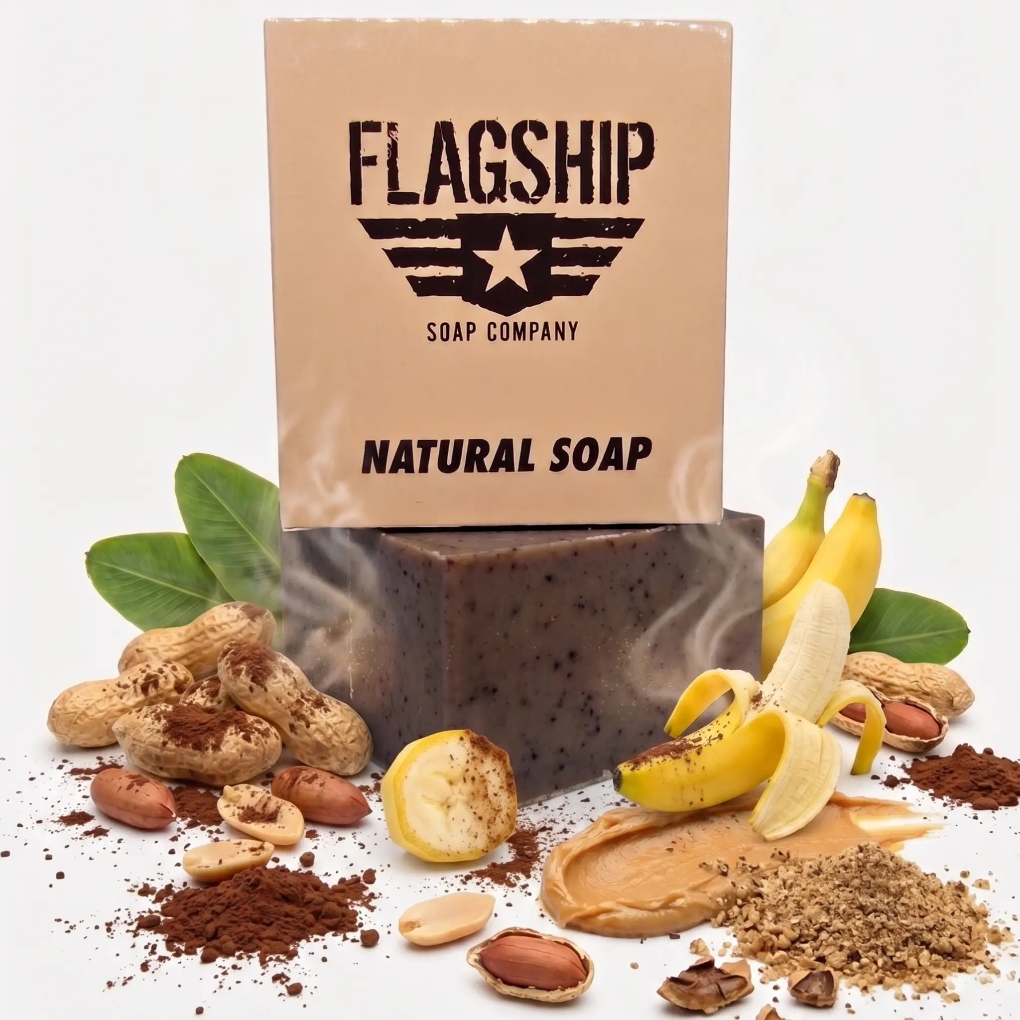 Flagship Soap Company "Brick Maker" box (the back version, showing the full "FLAGSHIP SOAP COMPANY" and "NATURAL SOAP" text) is positioned with its fresh ingredient profile: ripe bananas (whole, sliced, and peeled), whole peanuts in the shell, peanut butter spread, cocoa powder, and walnut shells (whole and crushed). Highlighting the moisturizing formulation (Coconut, Palm, Avocado oils, Shea Butter) and its medium exfoliation grit (walnut shells, cocoa). A deep-cleansing and hydrating bar