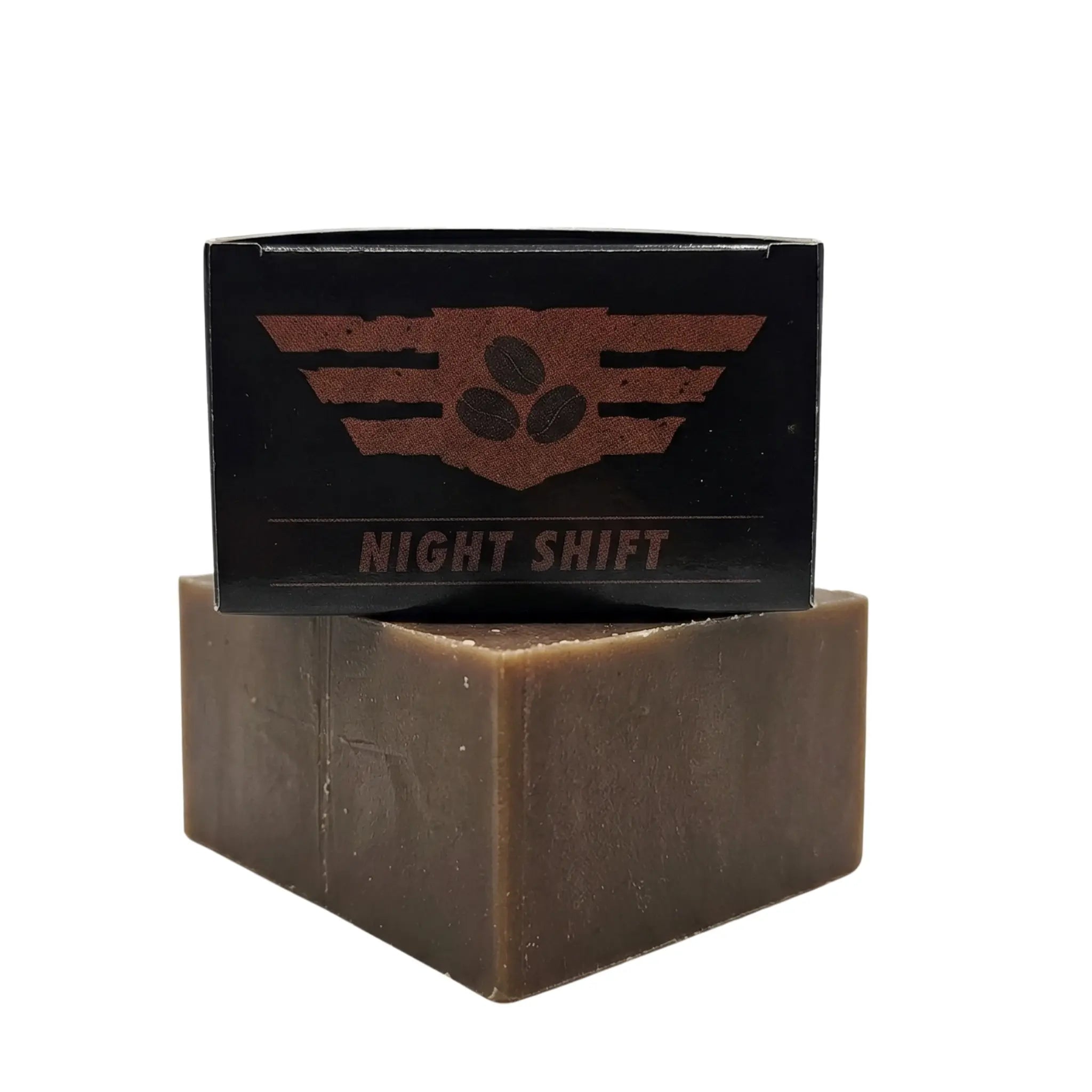 Lifestyle product shot of Flagship Soap surrounded by fresh roasted coffee beans and raw cocoa nibs, illustrating the scent of fresh brewed coffee and the exfoliating properties of real cocoa.