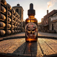 A bottle of Flagship Soap Company Bad Decisions Beard Oil standing on a wooden barrel at the Buffalo Trace Distillery. The label features a bearded skull and the product is infused with real Buffalo Trace Whiskey.