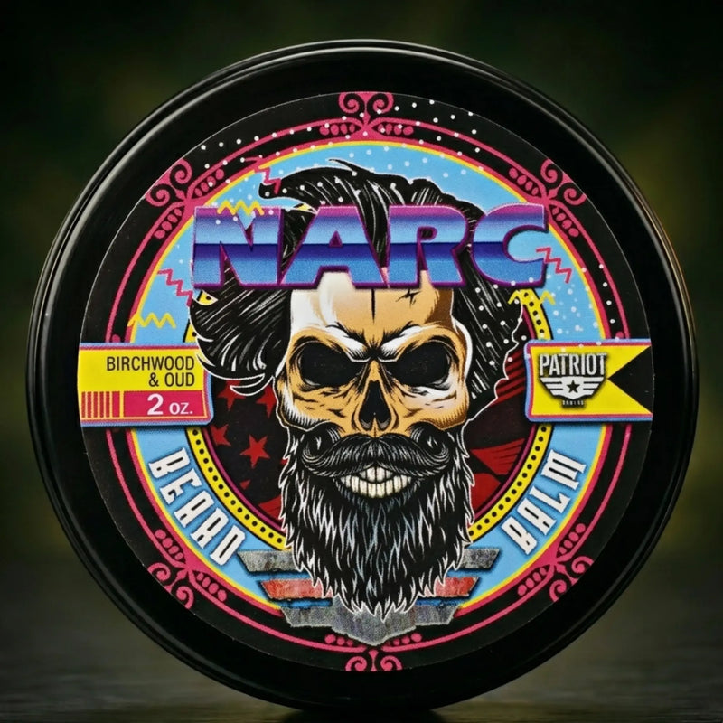 NARC Beard Balm by Flagship Soap Company featuring a Birchwood & Oud scent. The 80s synth-wave style label shows a bearded skull with big hair and neon accents. A unique, retro-themed beard conditioner for men who love a bold aesthetic.