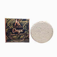 Klichy Onyx Vanilla and Cedarwood natural shampoo bar box next to 3 oz puck
