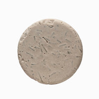 Close-up of Onyx cedarwood and vanilla natural shampoo bar puck texture