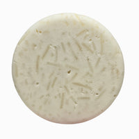 Close-up of Plain Jane fragrance-free natural shampoo bar puck texture