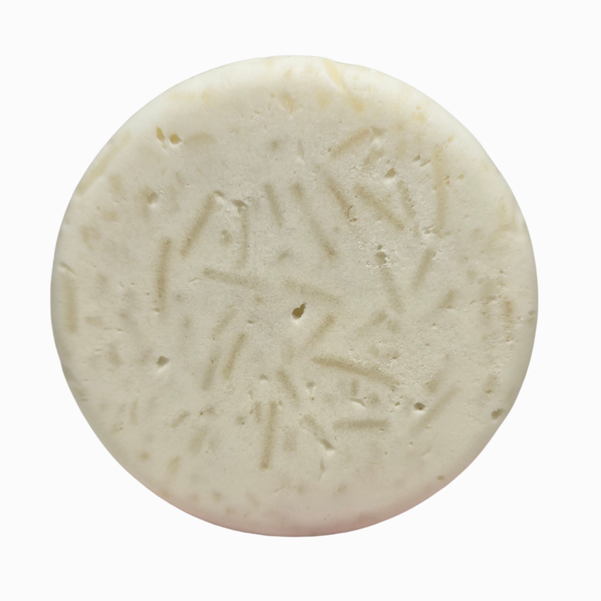 Close-up of Plain Jane fragrance-free natural beard wash puck texture