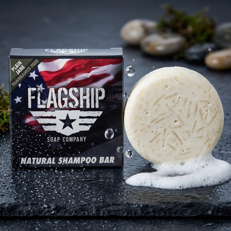 Plain Jane fragrance-free shampoo bar lathering into rich creamy foam on wet dark stone
