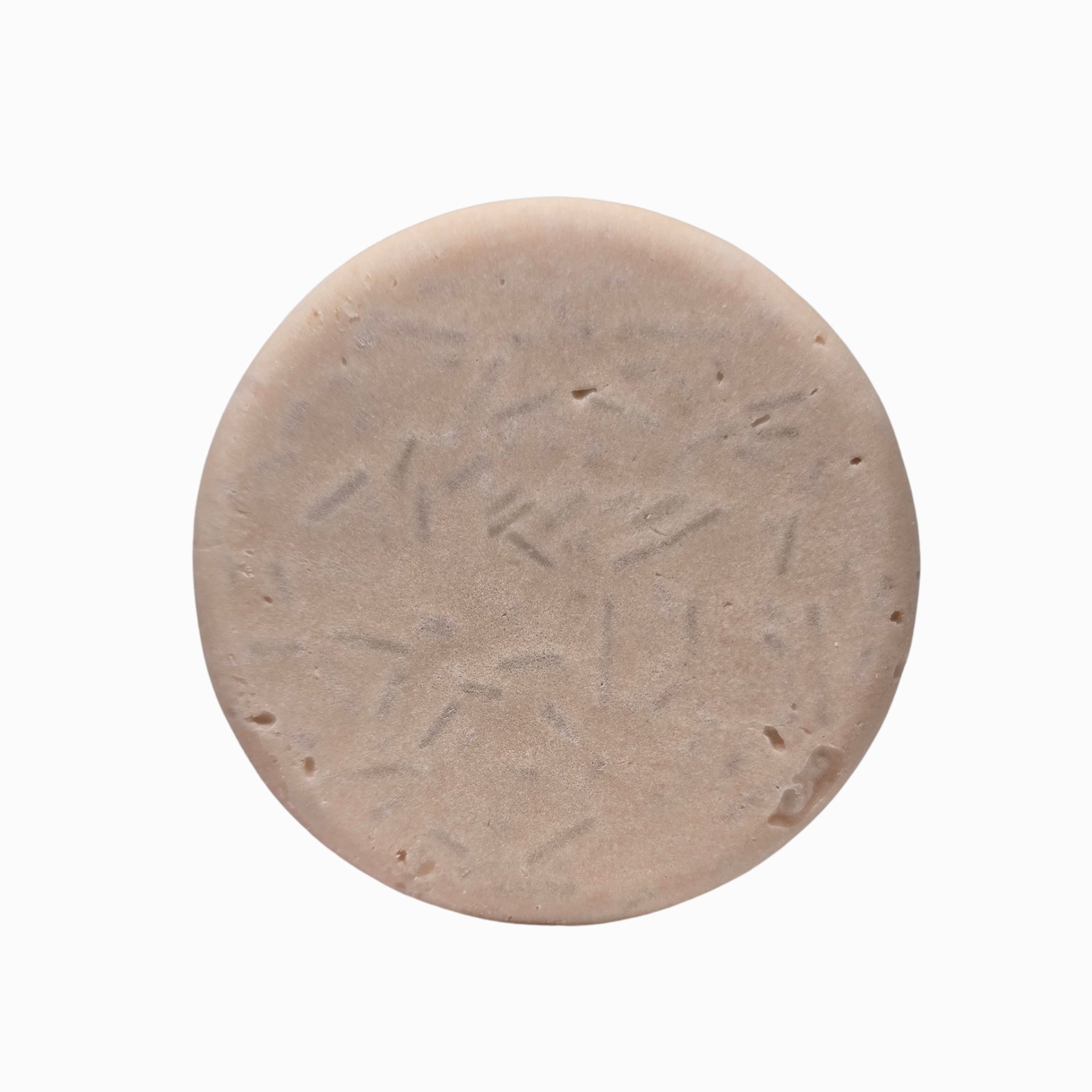 Close-up of Smooth Operator lavender and lemongrass natural shampoo bar puck texture