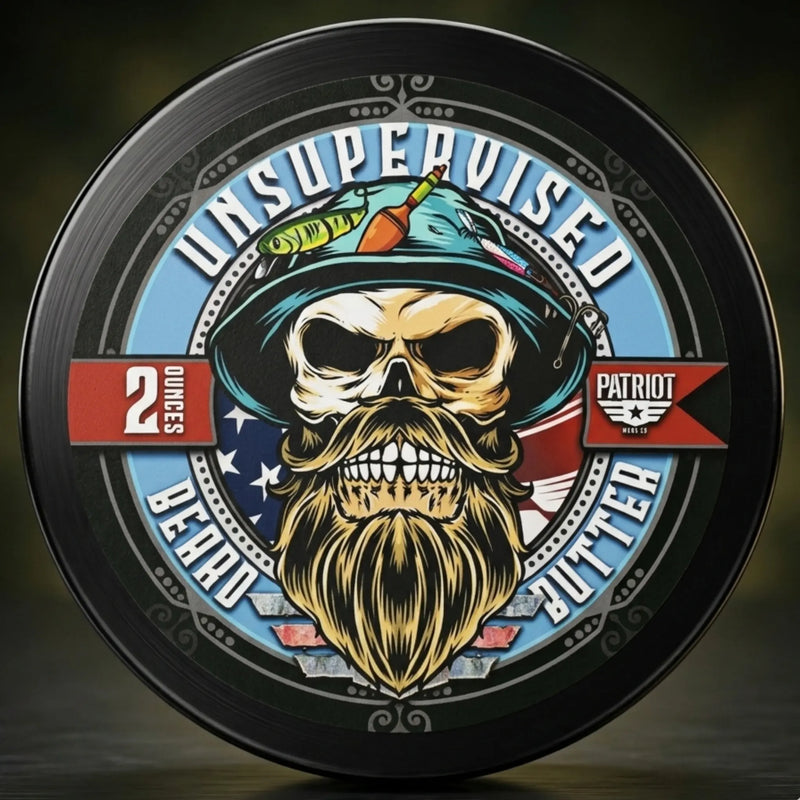 Unsupervised Beard Butter 2oz tin with a rugged fishing-themed design. Graphic features a bearded skull in a fisherman's hat with lures and bobbers. Perfect outdoorsman or fisherman gift with a patriotic American flag aesthetic.