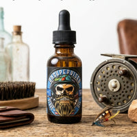 Top-selling Unsupervised beard oil with a bold masculine cologne scent, styled with a fly-fishing reel and hand-tied lures on a wooden surface.